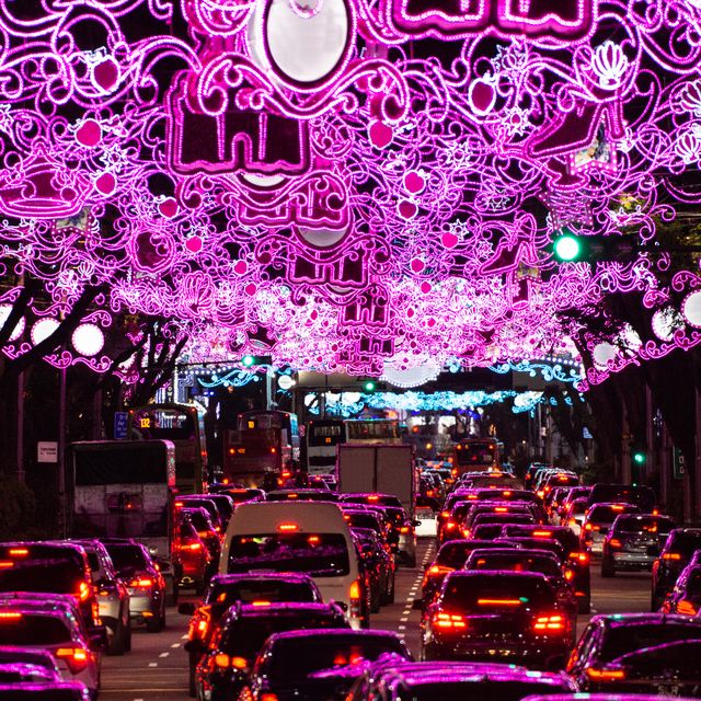 heavy traffic under illuminated arch on orchard street in singapore